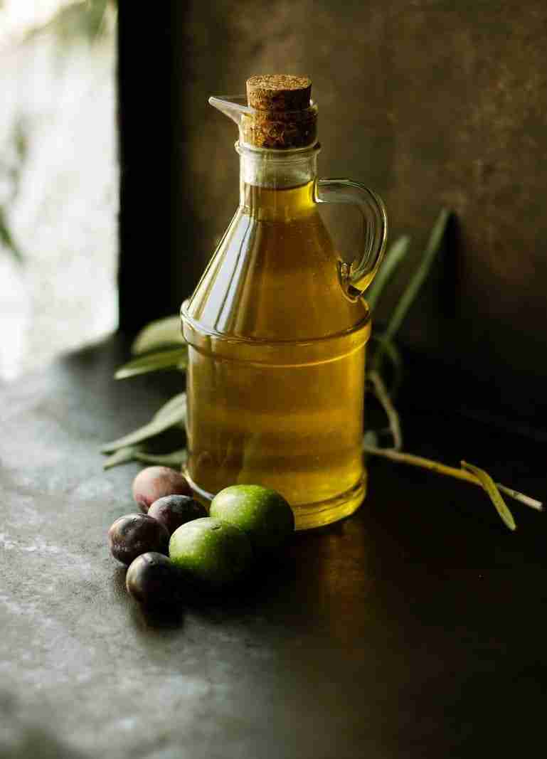 a jar of olive oil on a table