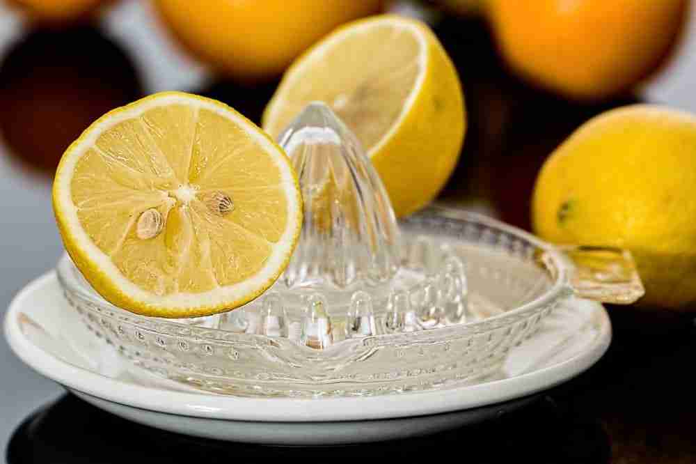 half a lemon placed on a squeezer ready to squeeze juice