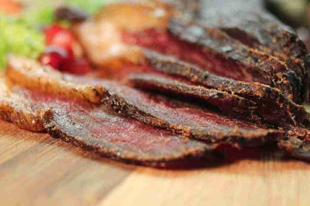 slices of dried beef jerky on a wooden chopping board